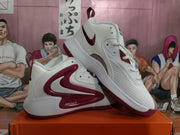 Angled view of the white and burgundy-red Nike basketball sneakers with contrasting side panels.