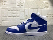 Lateral side view showing the blue collar, white upper panels, blue overlays, and textured white midsole.