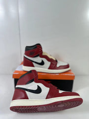 Side and outsole view of a red, white, and black high-top sneaker.