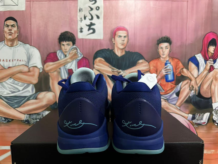 Rear view of blue Nike basketball shoes with turquoise outsoles