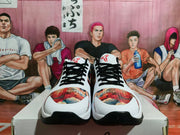 Front view of the sneaker pair showing black laces, white toe sections, multicolored toe panels, and black outsole edges.