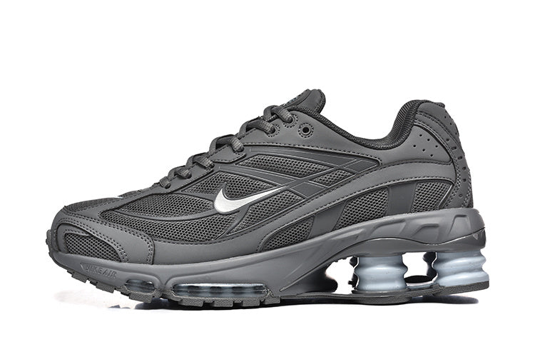 Side view of a dark grey Nike Shox Ride 2 sneaker with visible heel columns