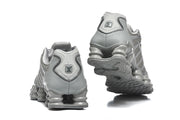 Rear and outsole views of grey Nike Shox TL sneakers.