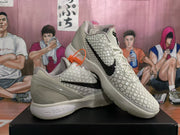 Pair of off-white Nike KD basketball sneakers displayed on a black shoe box, showing the black Swoosh, raised star detailing, and textured forefoot.