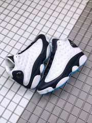 Pair of white, black, and blue high-top sneakers viewed from above.