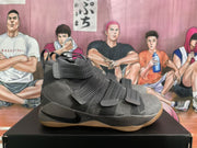 Side view showing the cool gray upper, layered straps, black Swoosh, and textured gum-colored outsole.