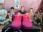 Front view of the pink and purple Nike sneakers showing the lace-up design and textured toe panels.