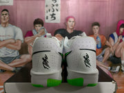 Rear view of the white sneakers showing Nike heel branding and green outsole sections.
