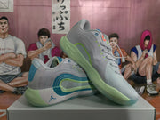 Angled view showing the pair of white Jordan sneakers with blue and green details