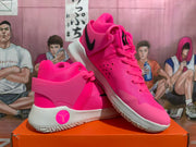 Angled side view showing the pink upper, heel overlay, black Swoosh, and white sole of the Nike KD Trey 5 VIII.