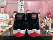 Rear view of the pair showing black heel panels, red detailing, white midsoles, and translucent red outsoles.