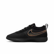 Black low-top sneaker with contrasting metallic-outline side swoosh and black outsole.