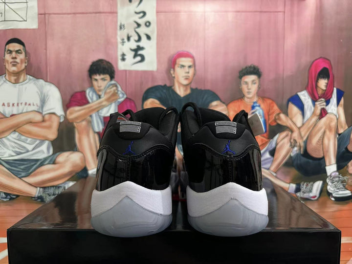 Rear view of black-and-white low-top basketball shoes showing the heel details and outsole