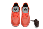 Bright red pair shown from above with gray tongues and dark laces beside the shoes.
