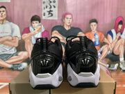 Rear view of the sneakers showing the heel pull tabs, glossy heel panels, and white outsole sections.