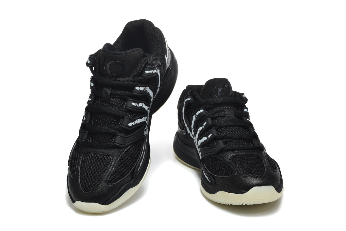 Pair of black Nike KD basketball shoes with skeleton graphics and pale outsoles, shown from the front.