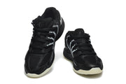 Pair of black Nike KD basketball shoes with skeleton graphics and pale outsoles, shown from the front.