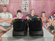 Rear view of the black sneakers showing padded heel panels and translucent outsole edges.