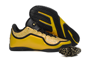 Yellow and black Nike LeBron 23 basketball shoe shown beside a black outsole with yellow accents.