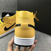 Close rear view of the yellow high-top sneaker showing stitching, ankle padding, and the white midsole.