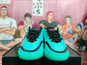 Front view of sky-blue Nike basketball shoes with black laces and trim and pink accents