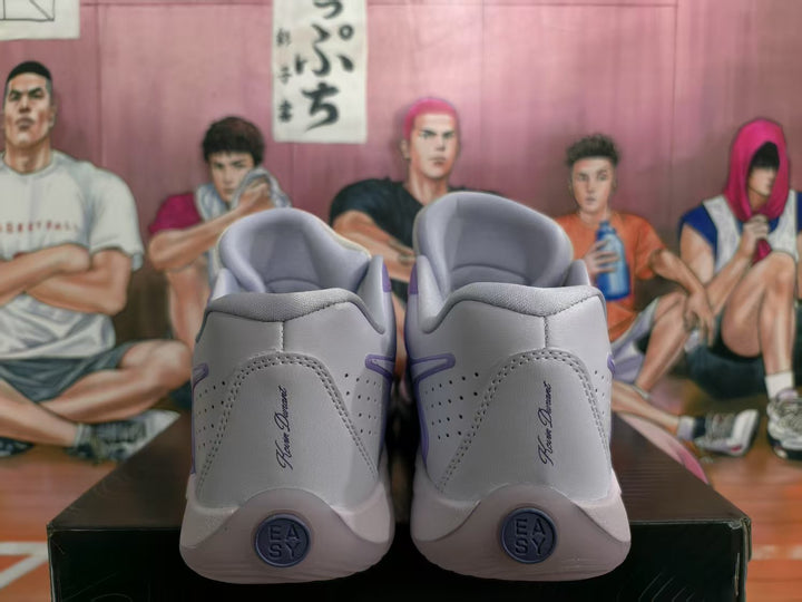 Rear view of lavender and white Nike basketball sneakers showing padded collars, perforated heel panels, and circular heel details.