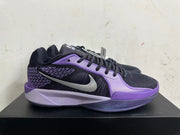 Side view of a black and purple basketball shoe with a silver Swoosh and patterned panel.