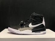 Side profile highlighting the black upper, white Swoosh, elephant-print panel, midfoot strap, and visible outsole section.