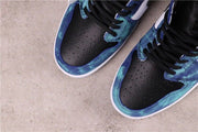 Top view showing black perforated toe boxes, black laces, and blue tie-dye panels.