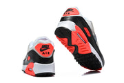 Rear and outsole views of Nike Air Max 90 sneakers with bright crimson and black details.
