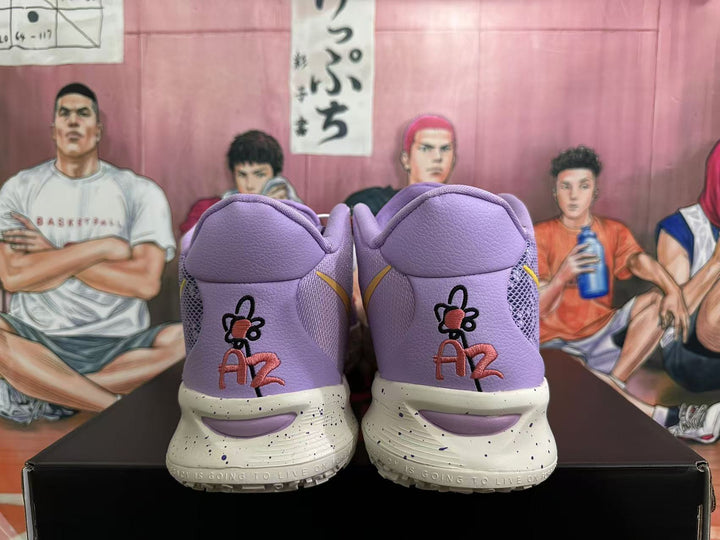 Rear view of lavender basketball sneakers showing padded collars, embroidered graphics, cream speckled midsoles and a black shoebox.