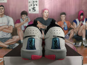 Rear view showing the heel details on grey Nike LeBron basketball shoes.