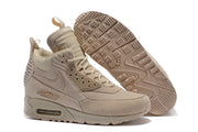 Light beige Nike Air Max 90 Winter sneakerboot beside a view of its treaded outsole.