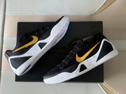 Angled top view of the sneakers highlighting the gold Swooshes and speckled side panels.