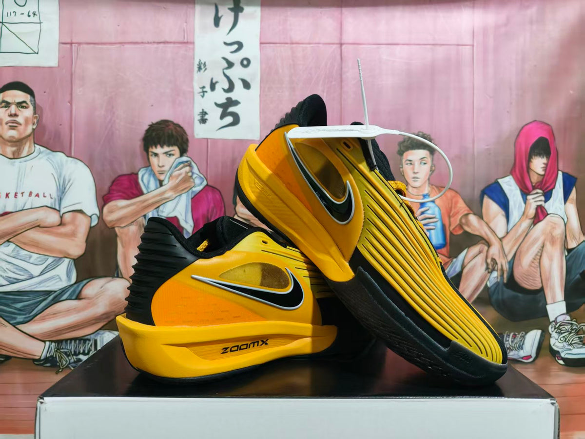 Pair of yellow and black Nike ZoomX sneakers shown from a side and sole angle.