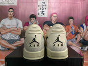 Rear view of the sneakers showing the heel logos and textured heel panels
