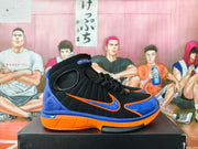 Side view of a Nike Air Huarache 2K4 basketball shoe in black, blue, and orange