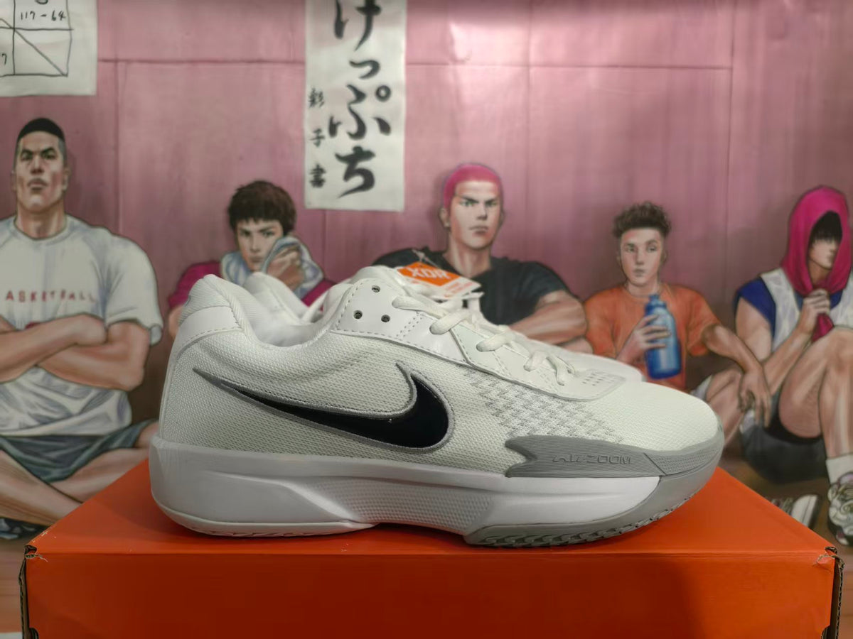 Side view of white and grey Nike Zoom basketball shoes with a black Swoosh.