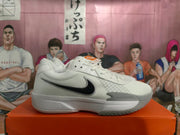 Side view of white and grey Nike Zoom basketball shoes with a black Swoosh.