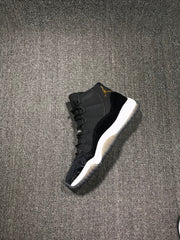 Single black high-top sneaker shown from a side angle on a textured gray surface.