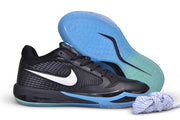 Black Nike Sabrina 4 shoe with blue outsole, shown beside the outsole