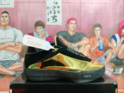 Side view showing the black upper, reflective gold panels, and dark midsole