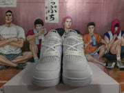 Front view of the white high-top sneakers showing the lace closure, structured toe boxes, and textured rubber outsoles.