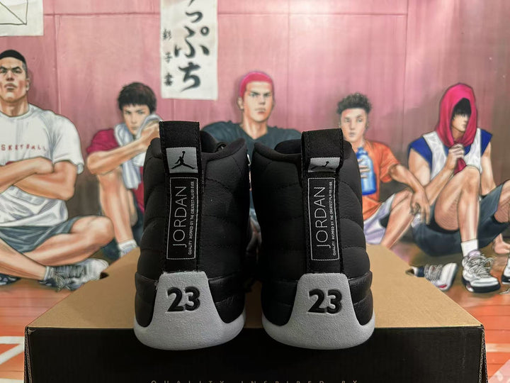 Rear view of black and grey Jordan 12 high-top sneakers