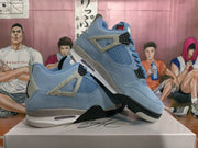 Angled view of the pair highlighting the light blue upper, side mesh panels, lace supports, and layered sole.