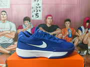 Side view of a blue Nike basketball shoe with a white Swoosh and midsole