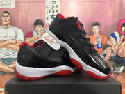 Pair of black and red Air Jordan 11 sneakers shown from the side.
