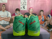 Rear view of the sneakers showing red “TWELVE” lettering on both green heels.