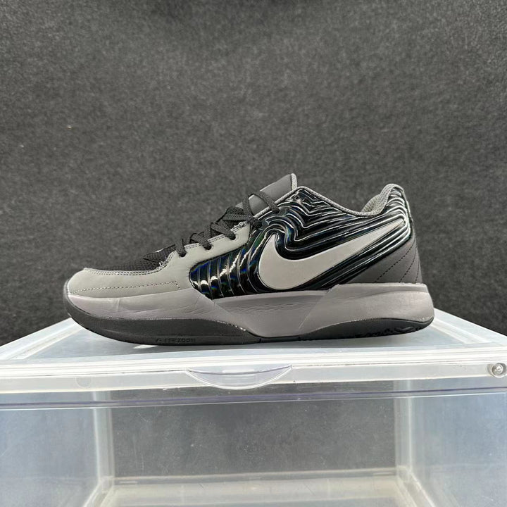 Side view of a black, gray, and silver Nike low-top sneaker with a large silver Swoosh and layered sole.