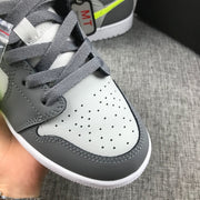 Close-up of the perforated light-grey toe box, charcoal overlays and grey laces.